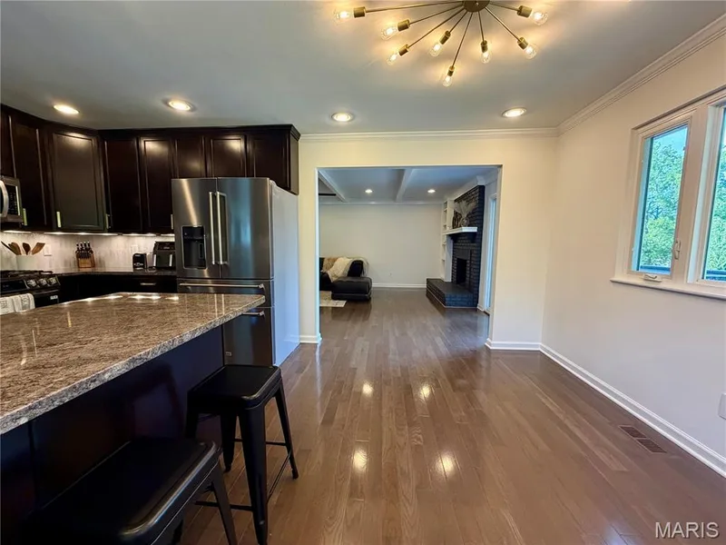 Hardwood flooring throughout, recessed lighting, and a modern sputnik chandelier — 584 Sunbridge Drive, Chesterfield, MO 63017