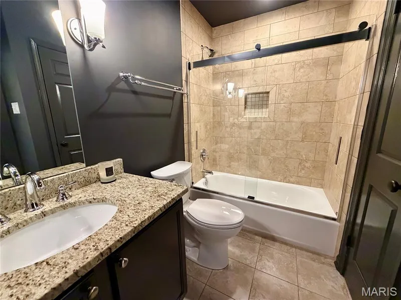 Bathroom featuring a vanity with an undermount sink, a chrome faucet, and a light-toned speckled countertop — 584 Sunbridge Drive, Chesterfield, MO 63017