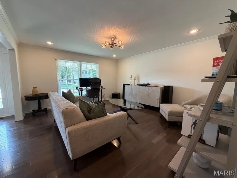 Wood-finish flooring, recessed lighting, crown molding, and a modern ceiling fixture — 584 Sunbridge Drive, Chesterfield, MO 63017