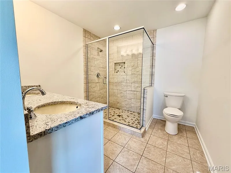 Single vanity with a granite-finish countertop — 584 Sunbridge Drive, Chesterfield, MO 63017