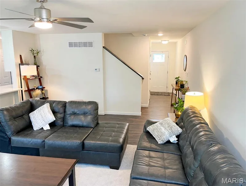 Open-concept living area featuring wood-finish flooring, a contemporary ceiling fan, and recessed lighting — 157 Day Lily Lane, Wentzville, MO 63385