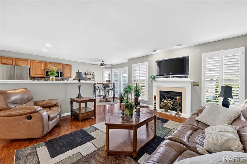 Recessed lighting, wood-finish flooring, built-in fireplace, ceiling fan, and white plantation shutters — 29 Edenshire Court #69B, Dardenne Prairie, MO 63368