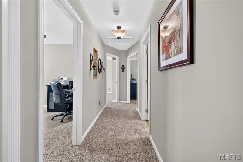 Hallway featuring neutral-toned carpet, recessed ceiling light fixtures, and white trim — 29 Edenshire Court #69B, Dardenne Prairie, MO 63368