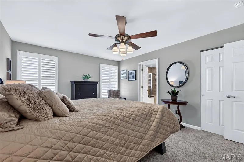 Carpeted flooring, recessed lighting, ceiling fan with light fixture, white plantation shutters, and a paneled interior door — 29 Edenshire Court #69B, Dardenne Prairie, MO 63368