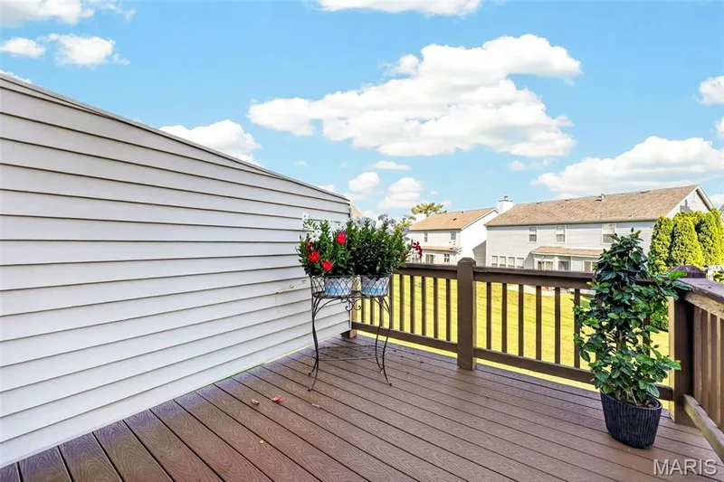 Expansive deck featuring wood-finish decking and a wooden railing — 29 Edenshire Court #69B, Dardenne Prairie, MO 63368