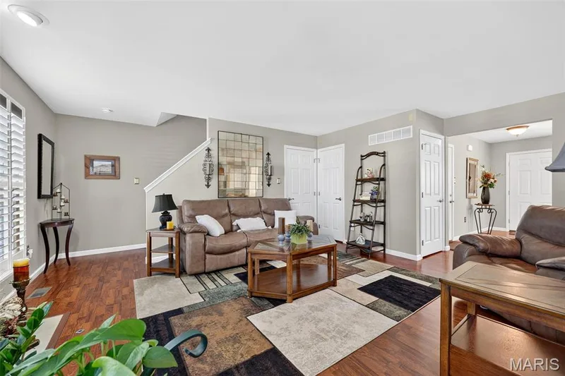 Hardwood-style flooring throughout, neutral paint palette, white trim, recessed lighting, and white plantation shutters — 29 Edenshire Court #69B, Dardenne Prairie, MO 63368