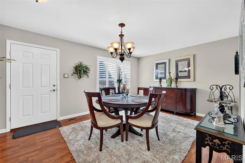Hardwood flooring, neutral wall tones, decorative window shutters, and a classic chandelier — 29 Edenshire Court #69B, Dardenne Prairie, MO 63368