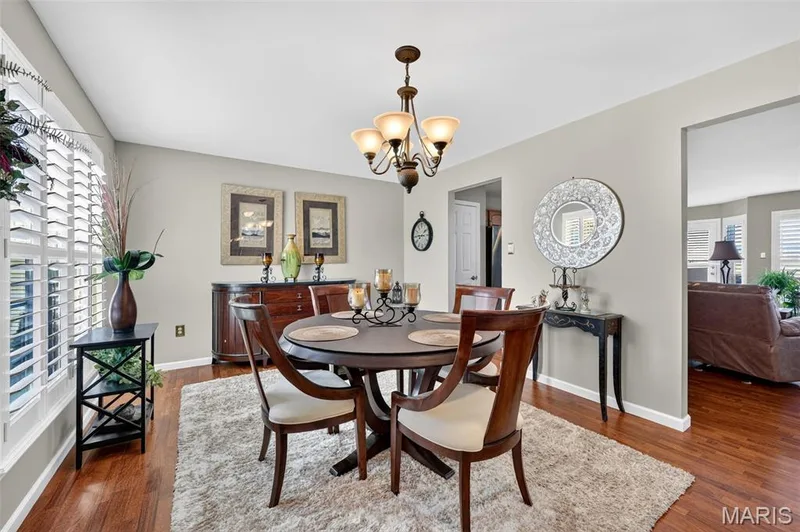Hardwood flooring, chandelier lighting, and a window with plantation shutters — 29 Edenshire Court #69B, Dardenne Prairie, MO 63368