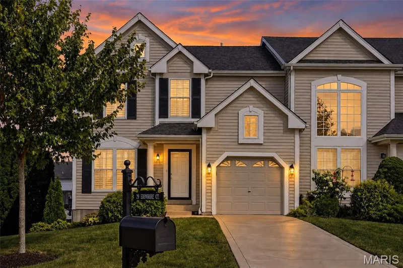 Contemporary residence featuring horizontal siding, an arched window, an attached garage, and a concrete driveway — 29 Edenshire Court #69B, Dardenne Prairie, MO 63368