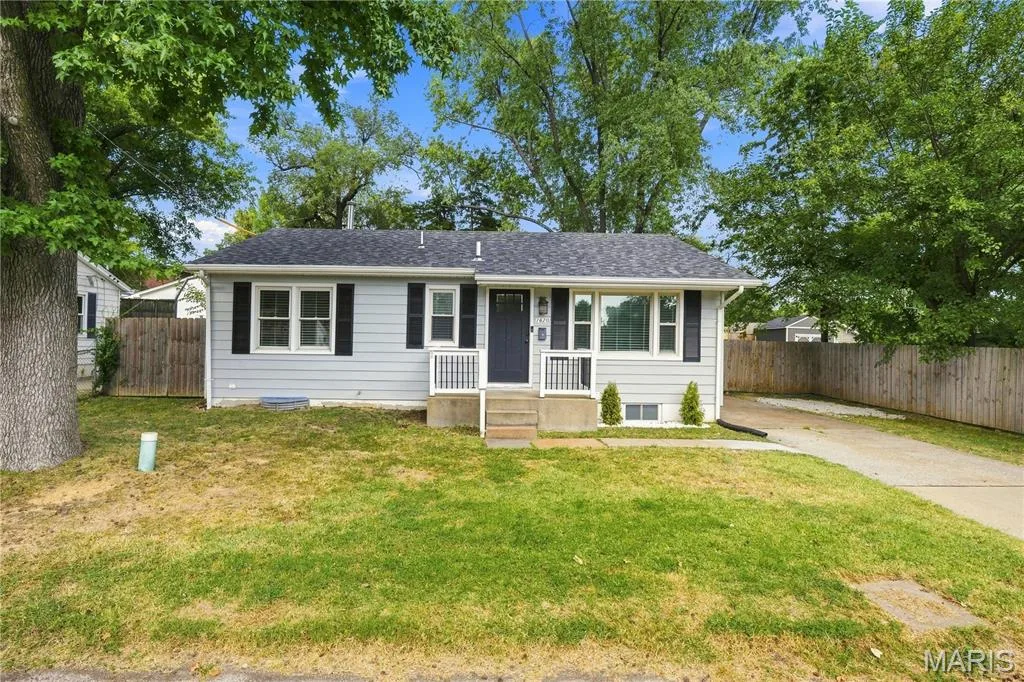 Light gray siding exterior with black shutters, white trim, and a dark blue entry door — 1620 Dale Avenue, St Charles, MO 63301