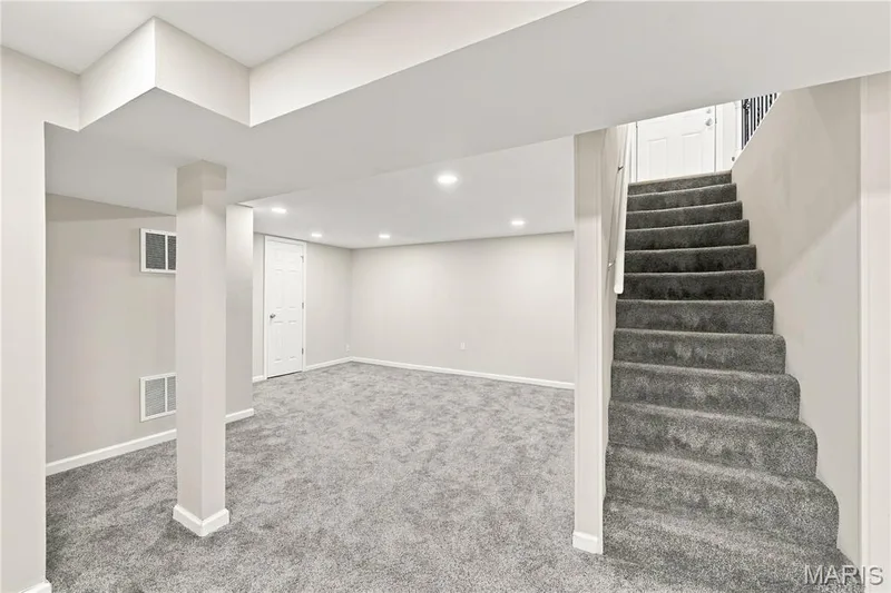 Spacious finished lower level with recessed lighting, light-toned walls, and grey carpeting — 1620 Dale Avenue, St Charles, MO 63301