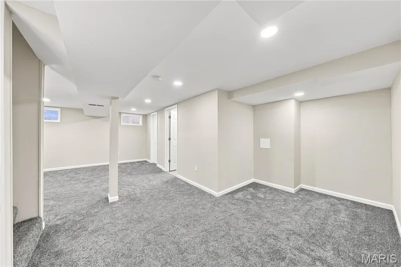 Expansive lower level featuring neutral wall tones, recessed lighting, carpet flooring, and multiple window openings — 1620 Dale Avenue, St Charles, MO 63301