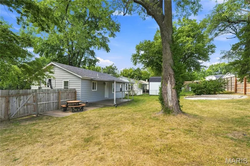 Single-story residence with siding exterior, fenced backyard, and mature trees — 1620 Dale Avenue, St Charles, MO 63301