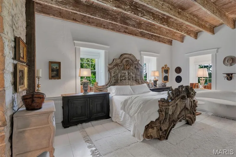 Exposed wood ceiling beams, white painted wood flooring, stone wall accents, and two windows with white trim — 2275 Highway F, Defiance, MO 63341
