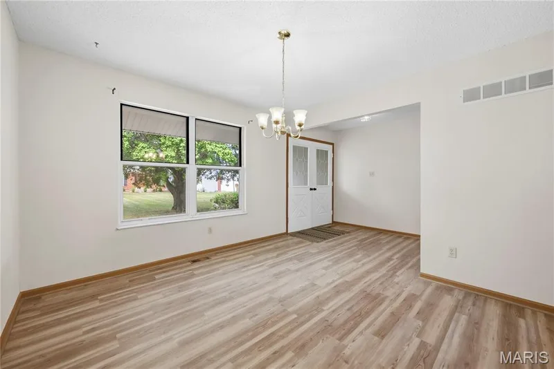 Luxury Vinyl Wood Plank Floors flow into the Front Dining Room with Wide Entry from the Foyer! — 1278 Stephenridge Drive, St Charles, MO 63304