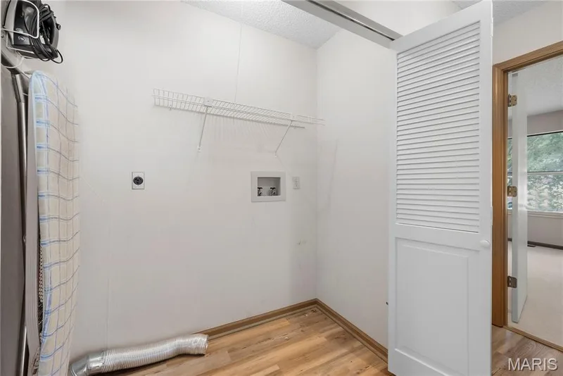 Main Floor Laundry is 6' Wide and features Shelving & Luxury Vinyl Wood Plank Floors! — 1278 Stephenridge Drive, St Charles, MO 63304