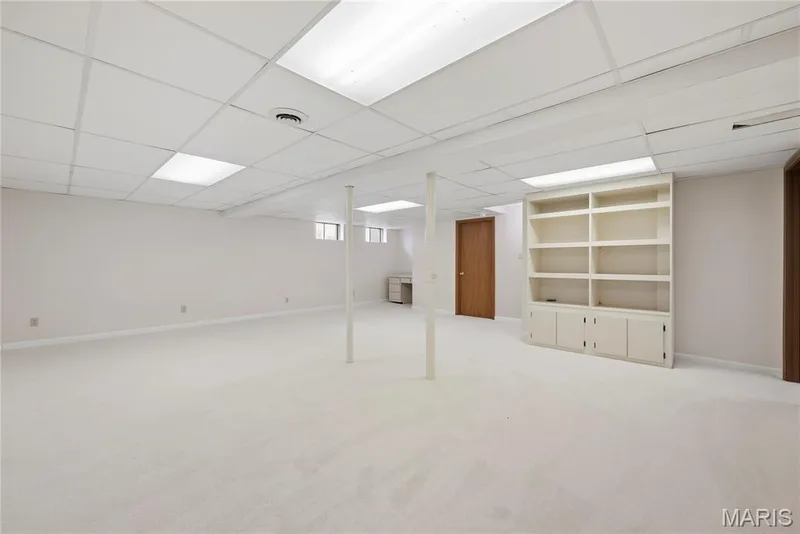 Lower Level Recreations has Windows, Built-In Shelving & Cabinetry!  Dorr pictured leads to the HUGE Storage Area! — 1278 Stephenridge Drive, St Charles, MO 63304