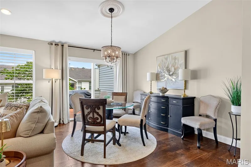 Hardwood flooring, vaulted ceiling, decorative ceiling medallion, sliding glass door, and a chandelier with a drum shade — 14737 Ladue Bluffs Crossing Drive, Chesterfield, MO 63017