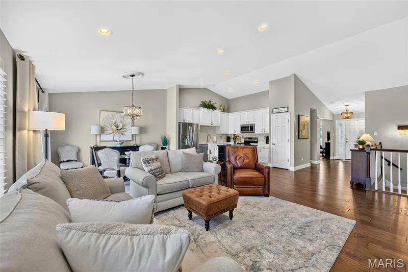 Open-concept living space featuring wood flooring, recessed lighting, and vaulted ceilings — 14737 Ladue Bluffs Crossing Drive, Chesterfield, MO 63017