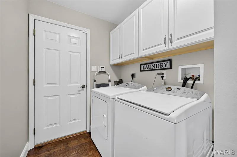 White upper cabinetry, wood-finish flooring, and light gray wall paint — 14737 Ladue Bluffs Crossing Drive, Chesterfield, MO 63017
