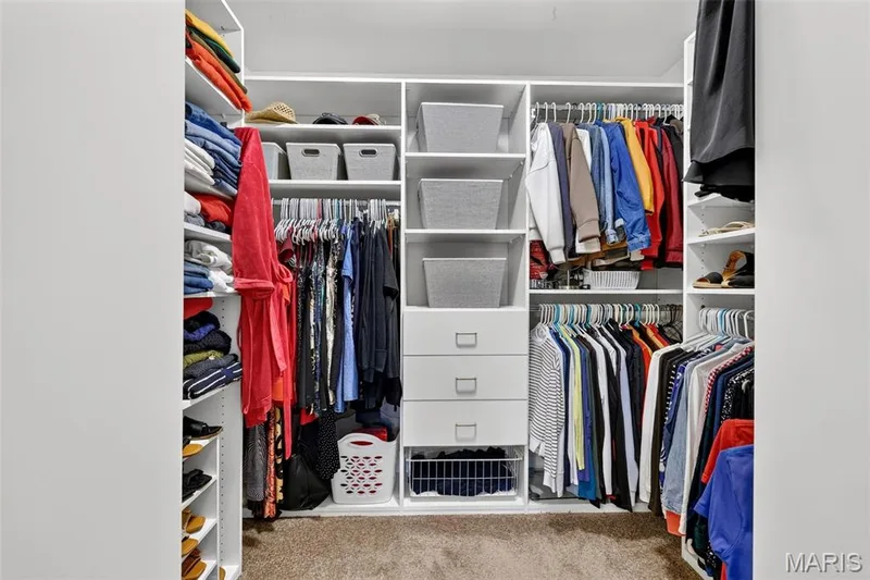 Custom closet system with multiple shelving units, integrated drawers, and ample hanging space — 14737 Ladue Bluffs Crossing Drive, Chesterfield, MO 63017