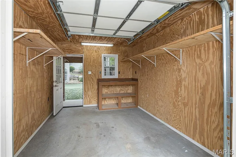 Garage door or service door, plus shelving and workbench — 10495 Walnut Lane, Foristell, MO 63348