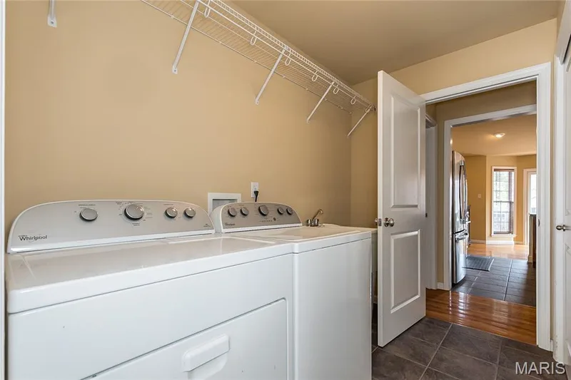 Main floor laundry with sink and large closet — 10495 Walnut Lane, Foristell, MO 63348
