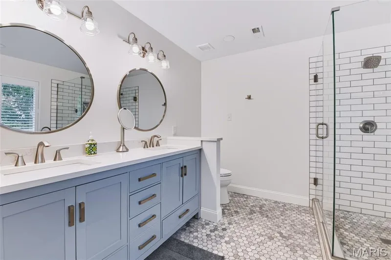 Updated primary bath with quartz countertops and marble flooring. — 209 Harbour Pointe Drive, Grover, MO 63040