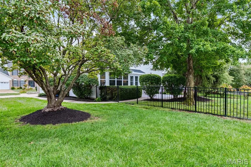 Backyard is fenced with black aluminum fencing from Chesterfield Fence. — 209 Harbour Pointe Drive, Grover, MO 63040
