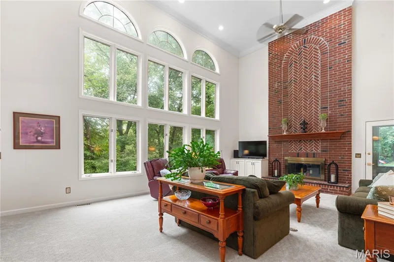 The over-sized great room is spacious and airy with soaring ceilings and tons of natural light. — 19342 Dogwood Valley Court, Wildwood, MO 63038