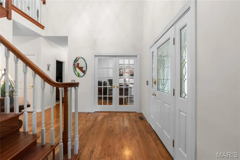 A home office sits beyond the french doors and a comfortable living room flank the entrance foyer — 19342 Dogwood Valley Court, Wildwood, MO 63038