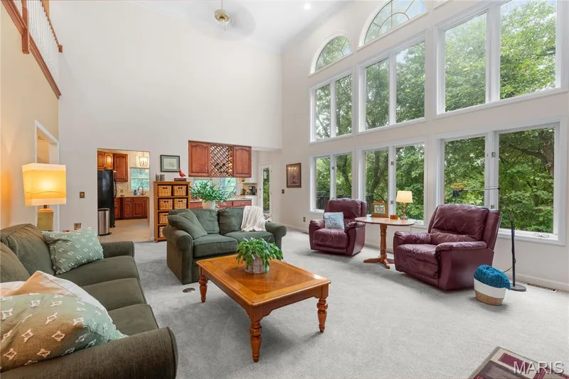Two-story, floor-to-ceiling windows topped with palladium windows offer breath-taking views of nature — 19342 Dogwood Valley Court, Wildwood, MO 63038