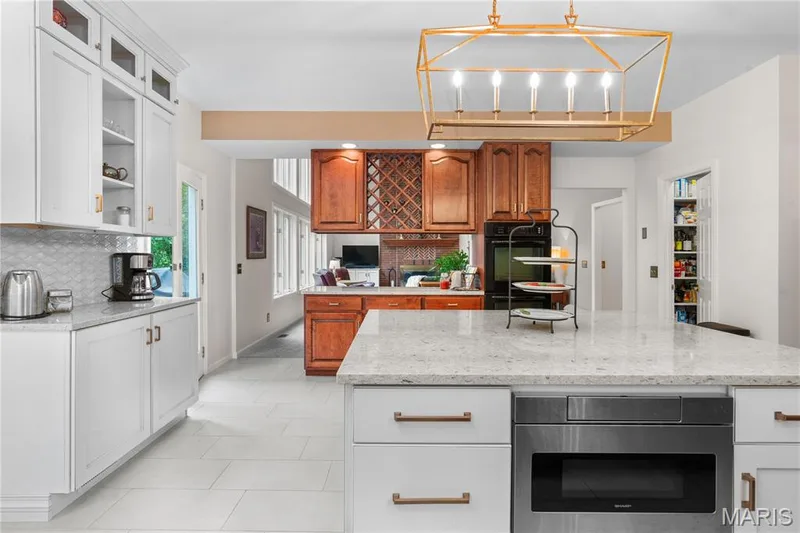 The stunning kitchen is seamlessly connected to the spacious great room and formal dining room for easy entertaining — 19342 Dogwood Valley Court, Wildwood, MO 63038