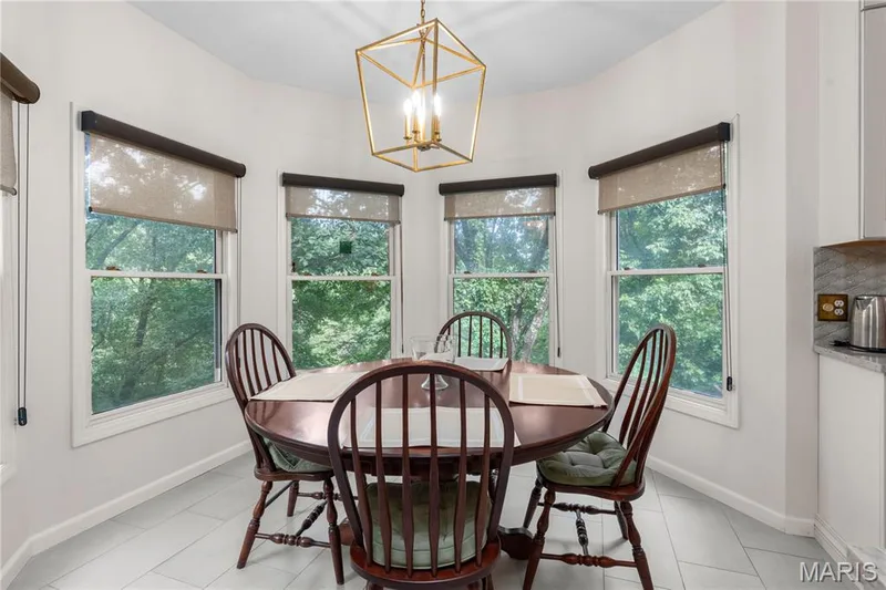 The generous eat-in kitchen area features a bay window with five individual windows offering sweeping views of the wooded back yard and pasture area — 19342 Dogwood Valley Court, Wildwood, MO 63038