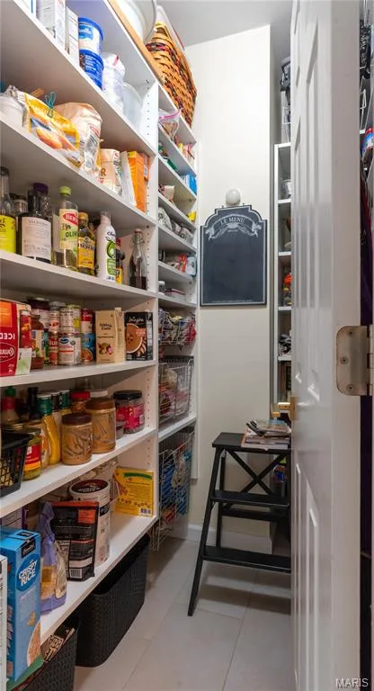 A walk-in pantry featuring extensive built-in shelving provides even more kitchen storage — 19342 Dogwood Valley Court, Wildwood, MO 63038