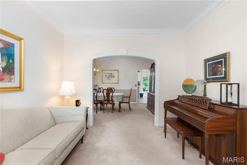 Arched doorway providing access between living room and formal dining room — 19342 Dogwood Valley Court, Wildwood, MO 63038