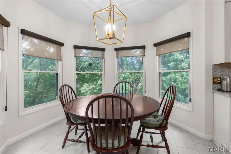 The generous eat-in kitchen area features a bay window with five individual windows offering sweeping views of the wooded back yard and pasture area — 19342 Dogwood Valley Court, Wildwood, MO 63038
