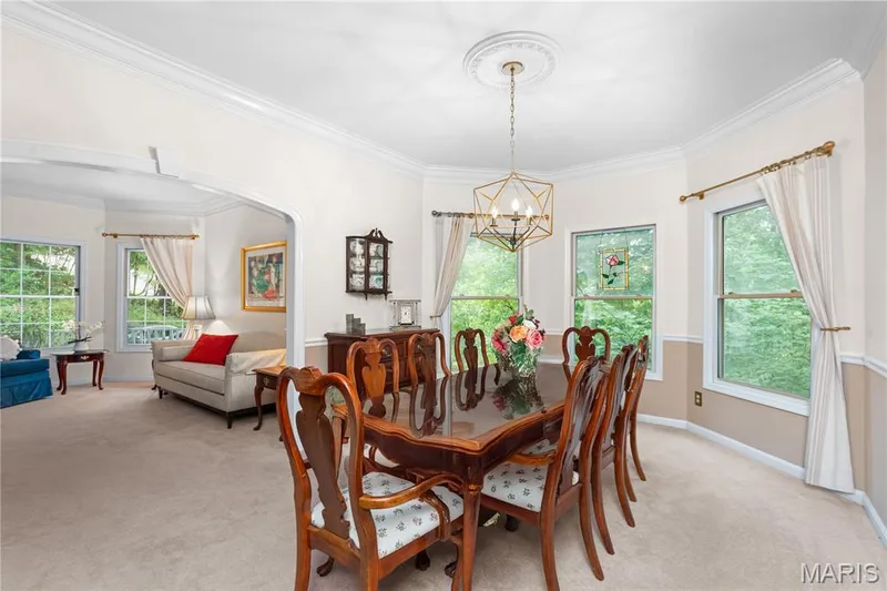 Tray ceiling with a decorative medallion, geometric chandelier, and crown molding — 19342 Dogwood Valley Court, Wildwood, MO 63038