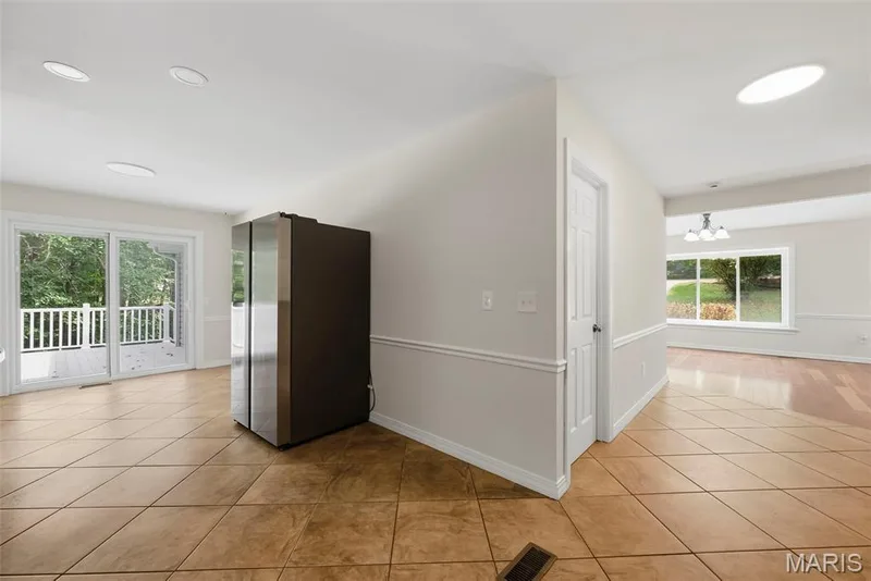 Kitchen with view into the breakfast area. this leads to one of the two composite decks. — 18409 Woodland Meadows Drive, Wildwood, MO 63038