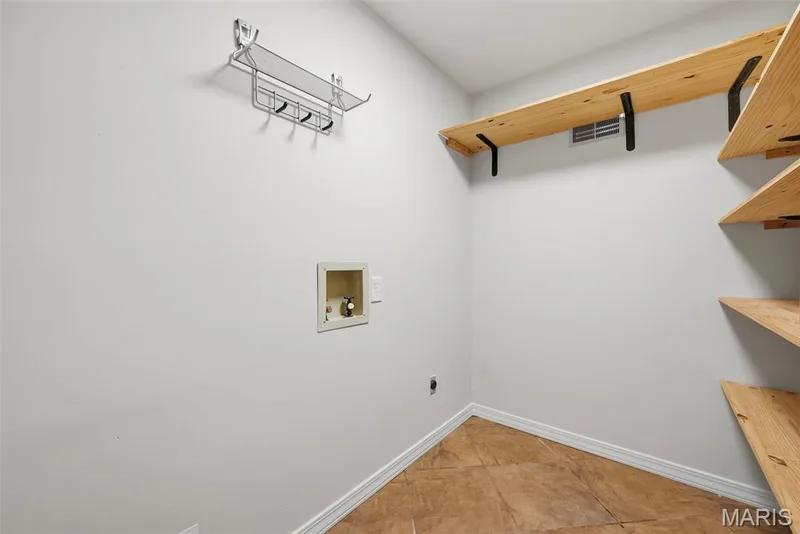 Pantry located off of kitchen with entrance to the garage as well as washer and dryer hook up. — 18409 Woodland Meadows Drive, Wildwood, MO 63038