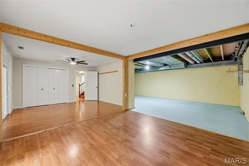 Bedroom three with view of the unfinished basement that has washer and dryer hook up as well. — 18409 Woodland Meadows Drive, Wildwood, MO 63038