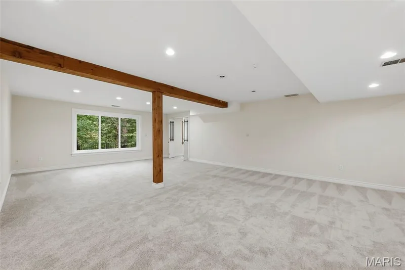 Media room with wood beans and view to back yard. — 18409 Woodland Meadows Drive, Wildwood, MO 63038