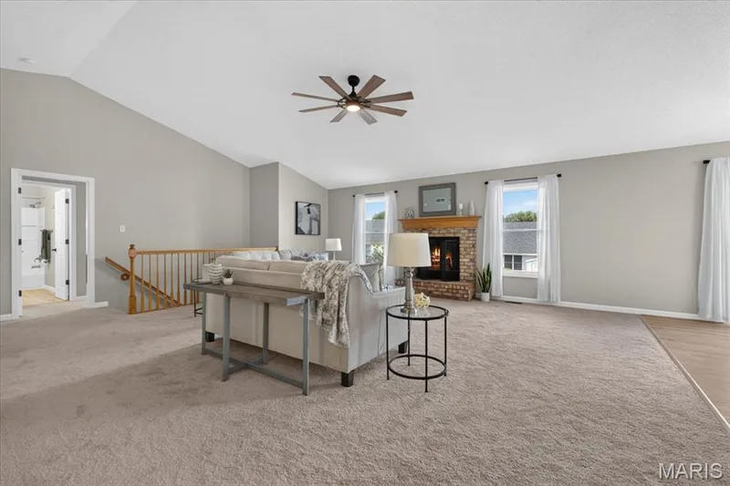 Vaulted ceiling, ceiling fan, brick fireplace, wood mantel, multiple windows — 89 Gregory Court, Wentzville, MO 63385