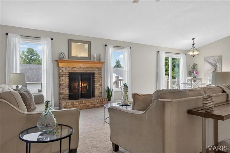 Brick-faced fireplace with a wood mantel — 89 Gregory Court, Wentzville, MO 63385