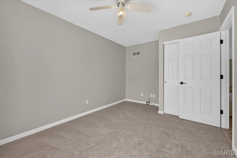 Neutral painted walls, light-toned carpet, a ceiling fan with integrated lighting, recessed lighting, and a paneled closet with sliding doors — 89 Gregory Court, Wentzville, MO 63385