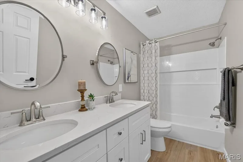 Dual vanity with undermount sinks, quartz countertops, and brushed nickel fixtures — 89 Gregory Court, Wentzville, MO 63385