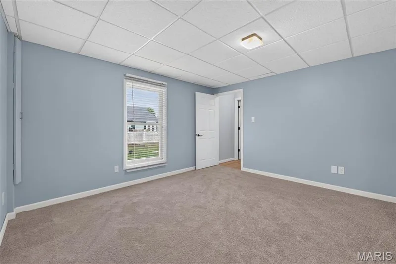 Neutral tone wall paint with window blinds and textured ceiling panels — 89 Gregory Court, Wentzville, MO 63385