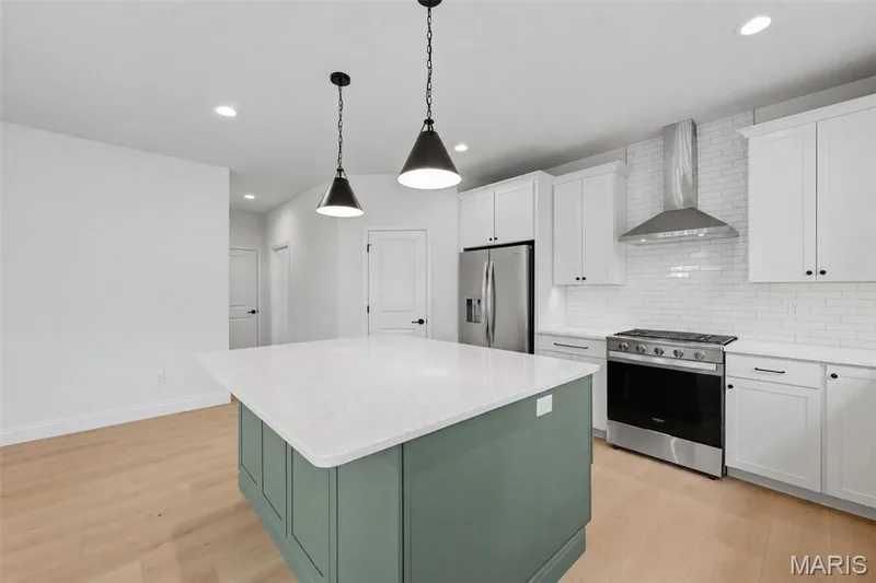 On Trend Kitchen with Contrasting Color Island and Quartz Countertops — 547 Ryehill Drive, St Peters, MO 63376