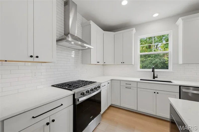 Gas Range and Stainless Steel Chimney Hood with Tile Backsplash — 547 Ryehill Drive, St Peters, MO 63376