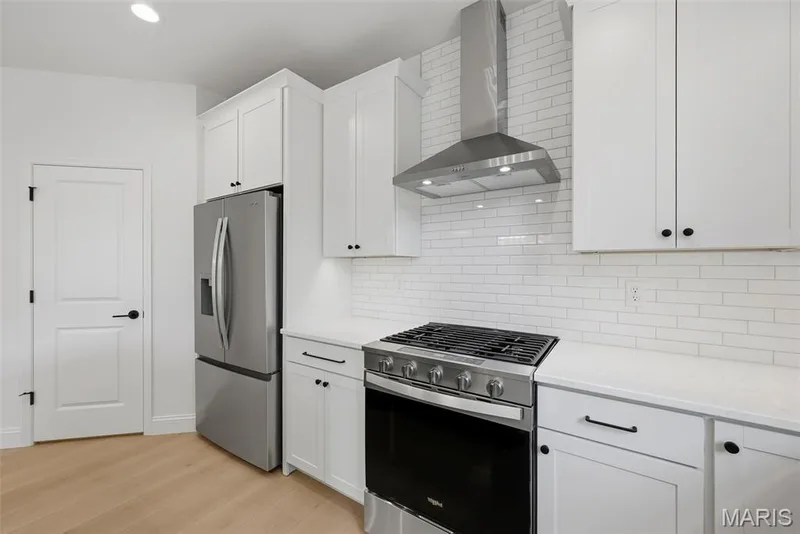 Kitchen with Walk in Pantry, Refrigerator, Gas Range and Stainless Steel Range Hood — 547 Ryehill Drive, St Peters, MO 63376